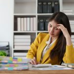 Deadline with young business woman feeling stressed concept. Business woman working at office